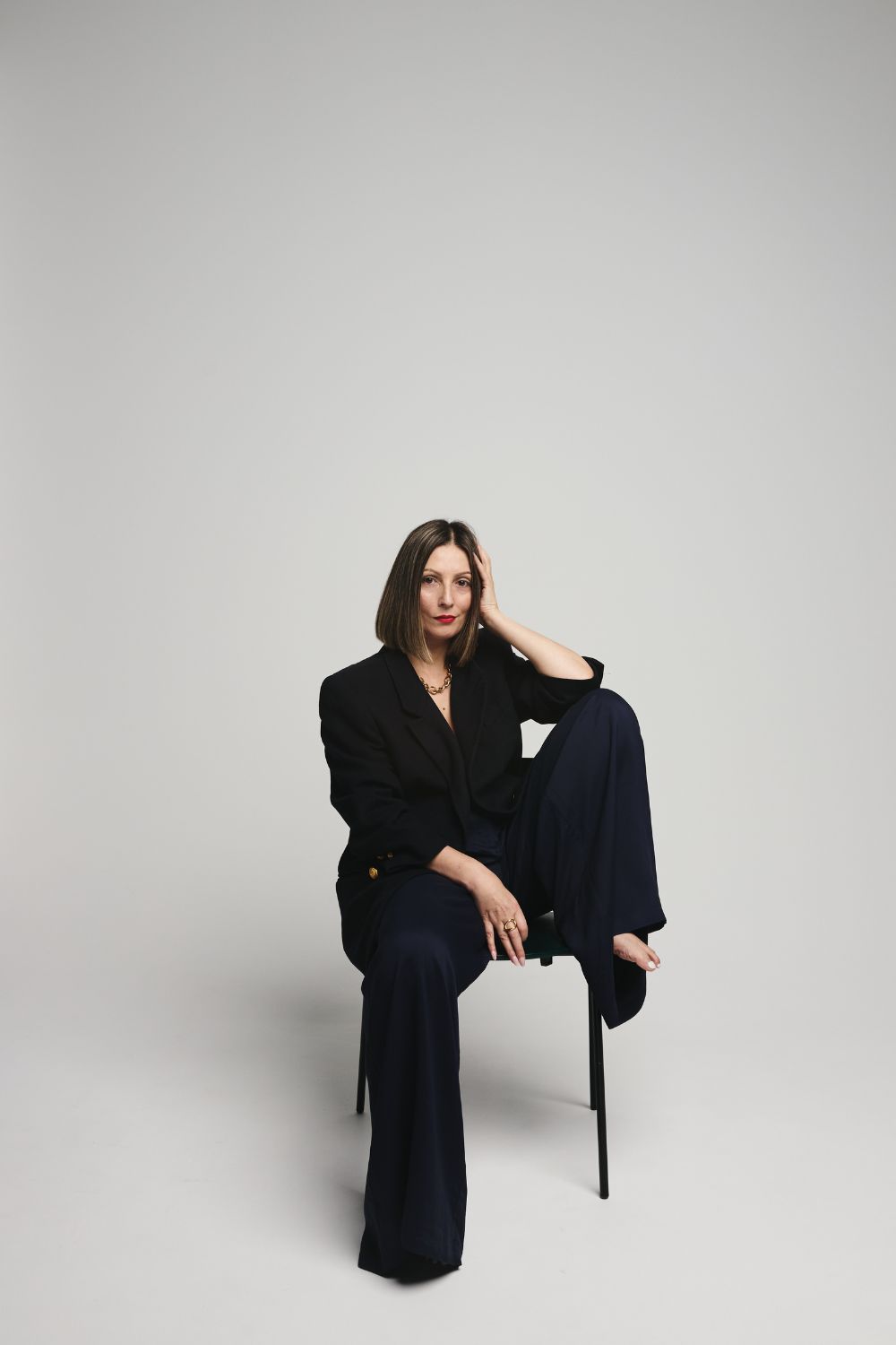 Sustainable Luxury Stylist - Elegant Powerful Pose in Sustainable Vintage Navy Blazer and wide leg trousers by a Sustainable Brand.