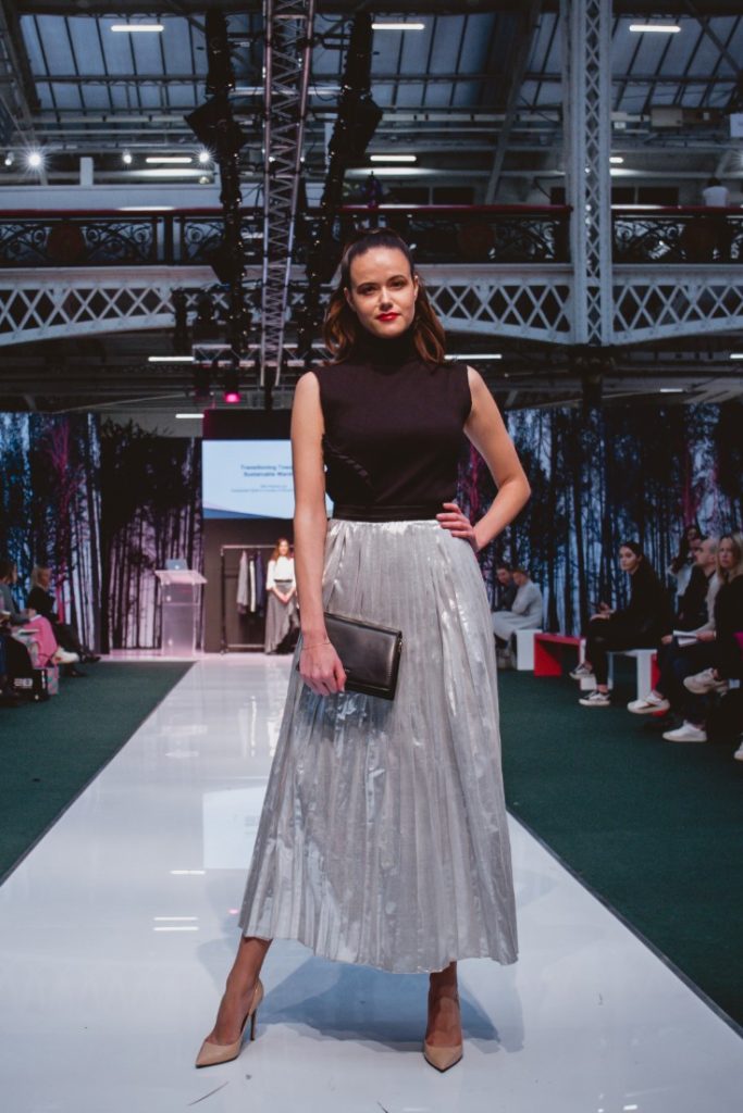 Model Amanda Sarco Styled By Roberta Lee, Pure London Runway Feb 2020 | Conscious Fashion Brands | Black Dress, Metallic Skirt, Black Clutch
