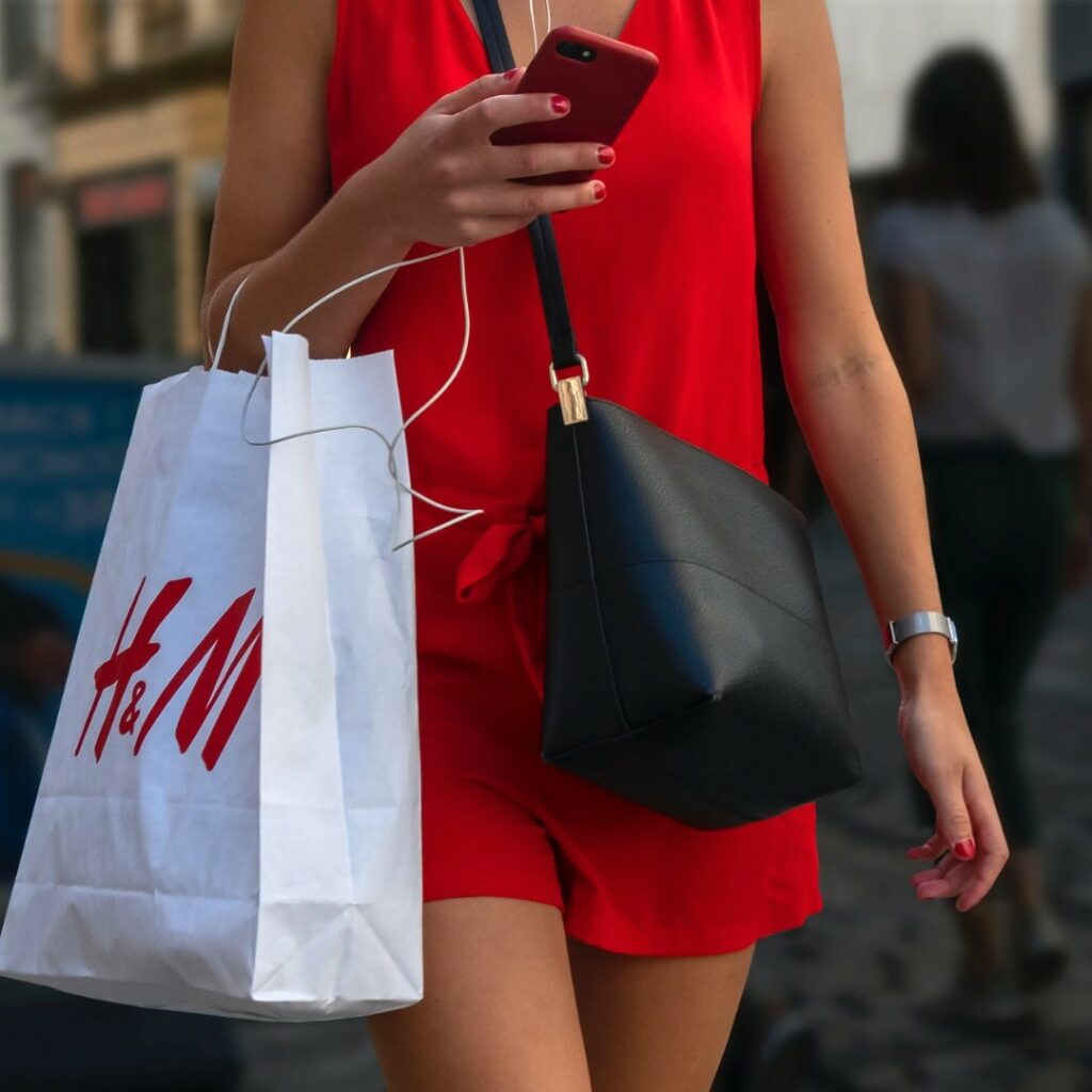 Woman shopping at highstreet retailer H&M | Fast fashion brand
