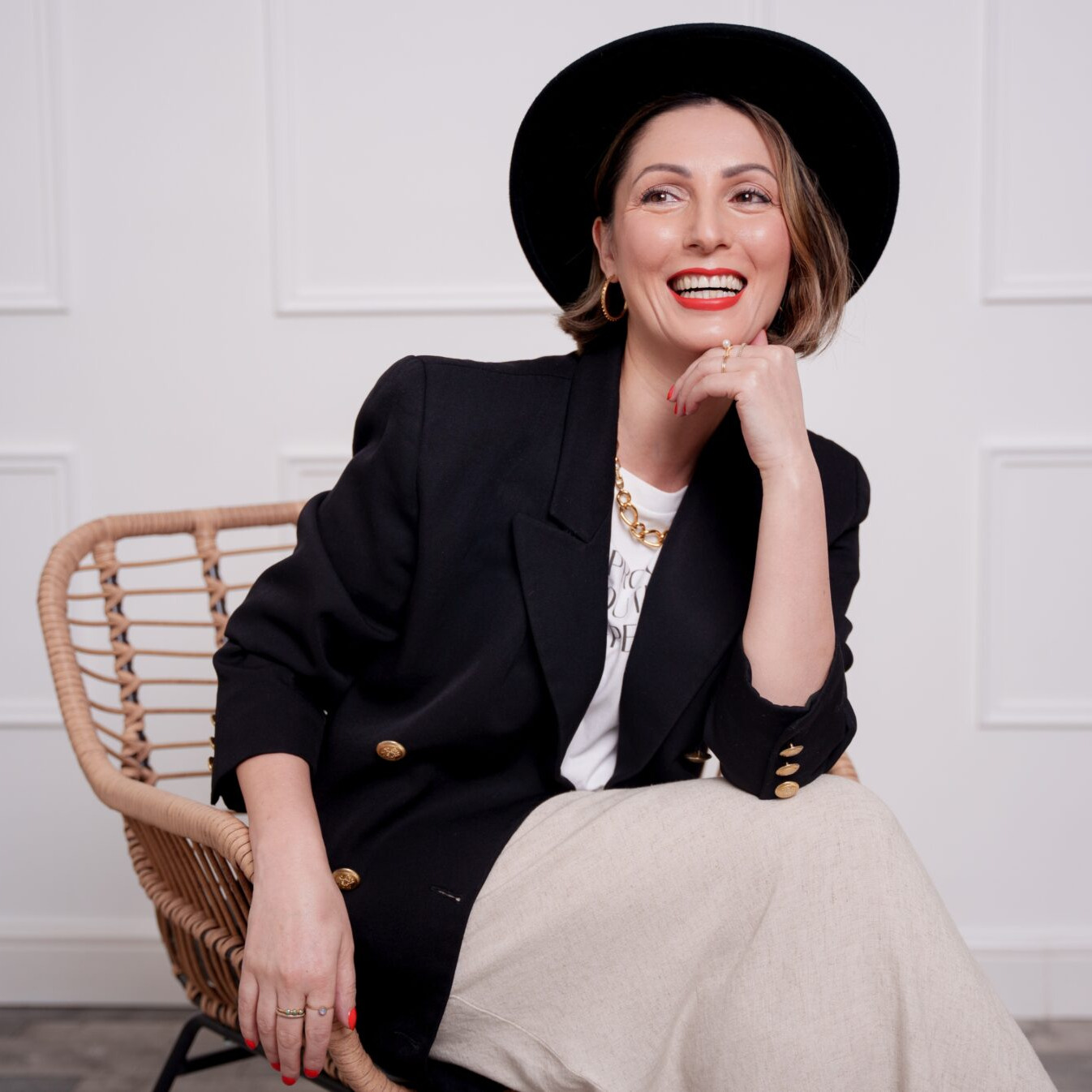 Sustainable fashion Stylist Roberta Lee, sits in a chair smiling