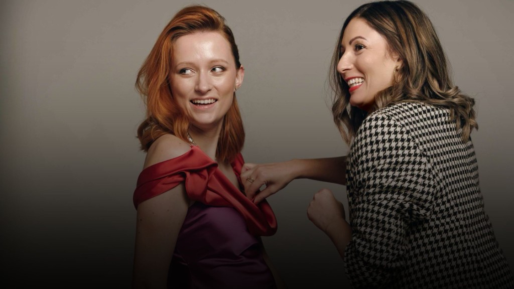 Commercial editorial styling — two women, red dress and houndstooth